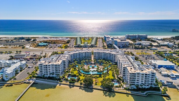 A resort with a central pool, multiple buildings, and a beach. - Destin West G116~ Ground Floor ~ Beachfront ~ Handicap Accessible! (Fort Walton Beach)