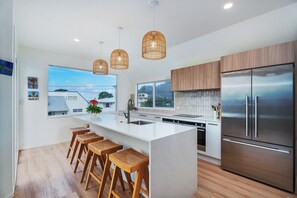 Enjoy cooking in this well-lit kitchen with a large island and bar stools.