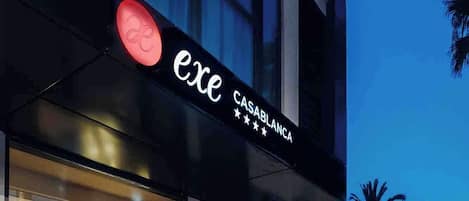 A modern building with a sign reading "exe CASABLANCA" and a visible entrance.