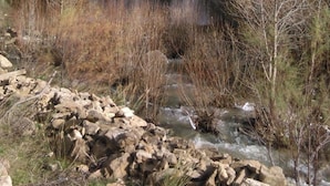 A waterfall cascading down a rocky cliff surrounded by sparse vegetation. - Corleone bed and breakfast  (Corleone)