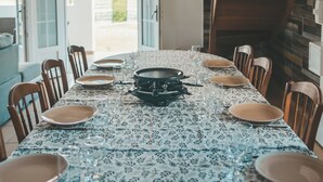 A dining area with a table set for six, featuring a patterned tablecloth and wooden chairs. - L'ESCAPADE DES HAUTS, spacious villa overlooking the Piton des Neiges. (Le Tampon)
