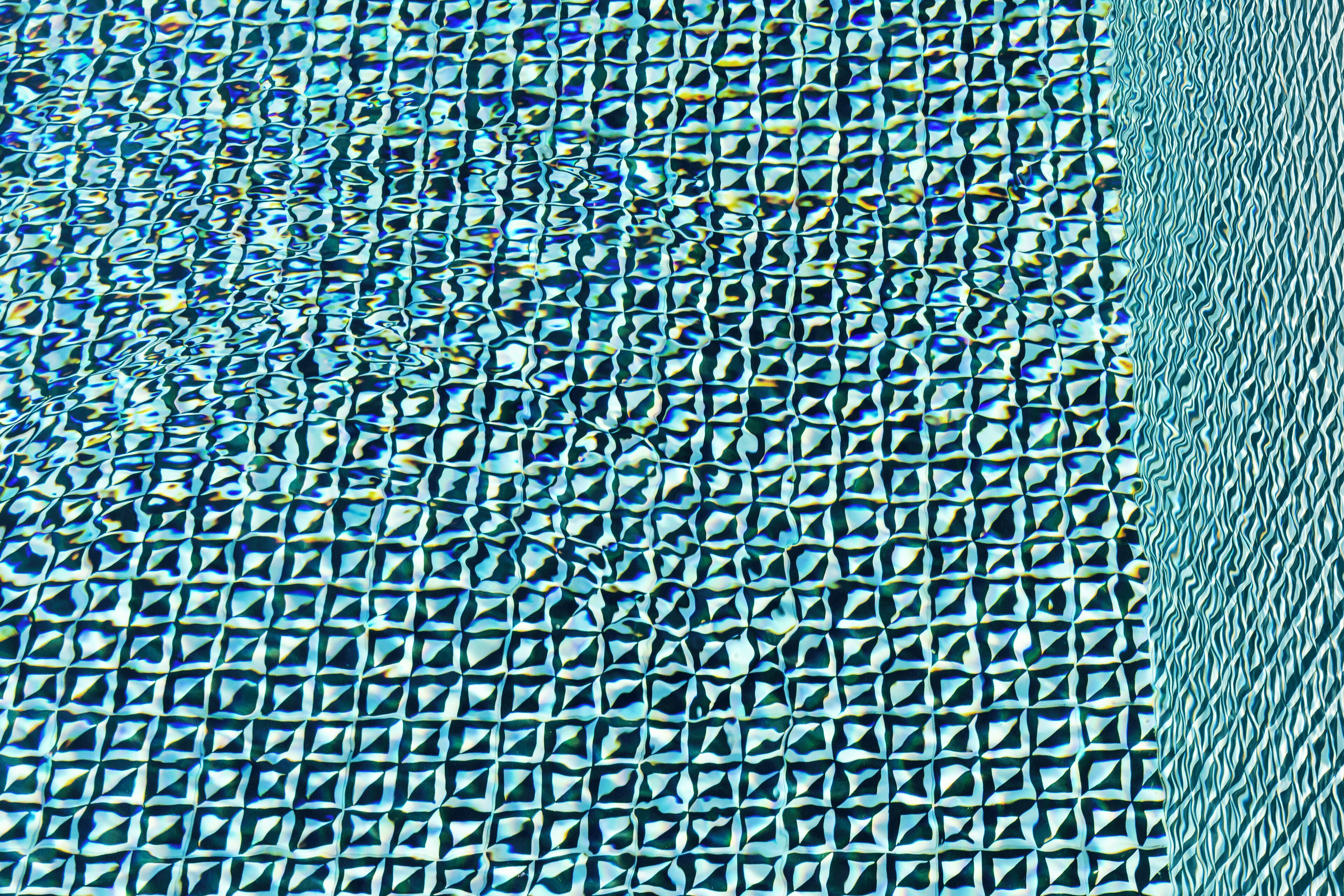 A close-up of a textured surface with a repeating geometric pattern.