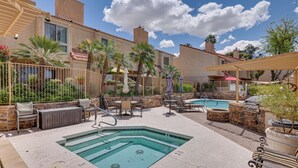 An outdoor pool area with lounge chairs, a hot tub, and a barbecue grill. - Golf Views & Pool Access: Central Scottsdale Condo (Scottsdale)