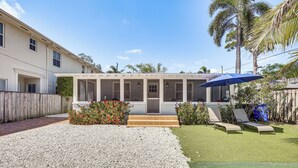 A house with a covered patio, a gravel driveway, and a lawn with two lounge chairs. - 4 Mi to Beaches: Tranquil Fort Lauderdale Escape (Fort Lauderdale)