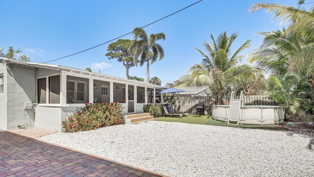 A single-story house with a covered porch, a gravel driveway, and a small lawn. - 4 Mi to Beaches: Tranquil Fort Lauderdale Escape (Fort Lauderdale)