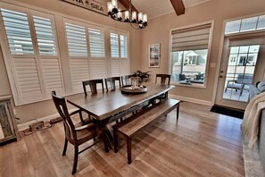 A dining area with a wooden table, chairs, and a chandelier. - Rehoboth Beach, Dog Friendly, 5BR, 3 Full Baths, Arbor-Lyn Community, Sleeps 12 (Rehoboth Beach)