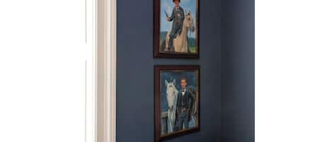 Two framed paintings on a wall.