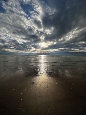A beach with a sunset, wet sand, and footprints. - Vacation Home for Rent, 150 Meters from the Beach—With Garage (Neufchâtel-Hardelot)