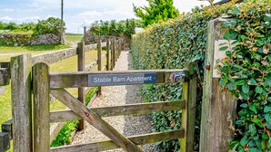 A wooden gate with a sign reading "Stable Barn Apartment." - Stable Barn Apartment at Bodmin Moor (St Breward)