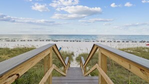 A wooden boardwalk leading to a beach with a clear view of the ocean and sky. - Gulf Views with Hot Tub, Garage and Bikes (Santa Rosa Beach)