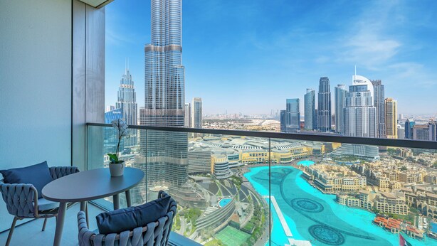 A balcony with a view of a city skyline, including a prominent skyscraper. - Sky-High Burj Khalifa and Fountain Views (Dubai)