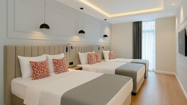 A hotel room with two beds, a large mirror, and a flat-screen TV. - Center Port Hotel Karaköy (Istanbul)