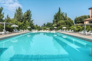 Seasonal outdoor pool, open 10:00 AM to 7:00 PM, pool umbrellas