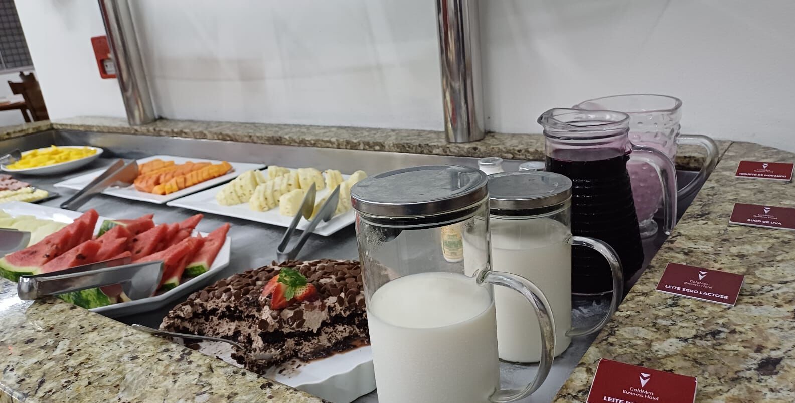 A breakfast buffet with various food items and beverages.