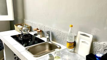 Fridge, stovetop, coffee grinder, cookware/dishes/utensils
