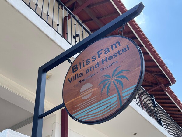 A wooden sign for BlissFam Villa and Hostel in Negombo, Sri Lanka. - BlissFam Villa & Hostel (Negombo)