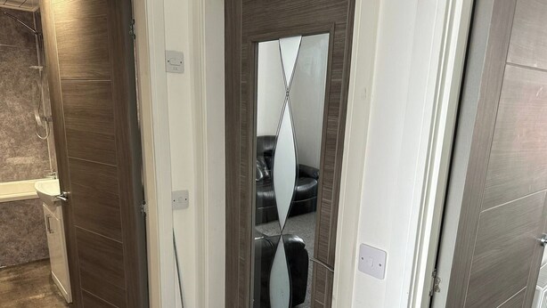 A modern bathroom with a shower, a toilet, and a sink.