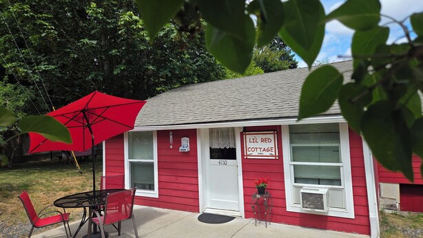 A red cottage with a sign reading "LIL RED COTTAGE" and a number "4110". - Offut Lake!  Pet friendly cottage with lake access..  Bring your fishing rod! (Tenino)