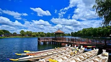 A dock with several boats, a gazebo, and a pier extending into a body of water.