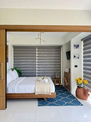 Premium bedding, laptop workspace, blackout drapes, soundproofing