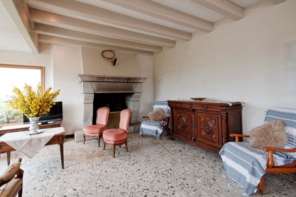 A cozy living room with a fireplace, a television, and comfortable seating.