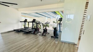 Un gimnasio amplio con cintas de correr, bicicletas estáticas y equipo de ejercicio.