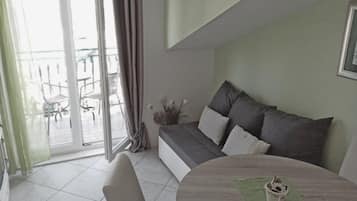 Apartment (Two Bedroom Apartment with Balcony an) | Living room | 32-inch flat-screen TV with cable channels