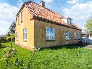 A two-story building with a red-tiled roof and a brick facade. - 4 Person Holiday Home in Skaerbaek (Skaerbaek)