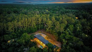 An aerial view of a forested area with a single building featuring a swimming pool and a covered patio area. - Floral City Oasis / Pool, BBQ Area & Forest View (Floral City)