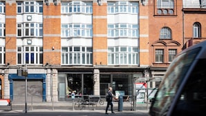 A multi-story building with a brick facade, large windows, and a ground-floor entrance with a glass door. - Urban Rest Dublin Central (Dublin)