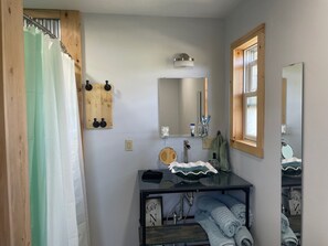 Shower, hair dryer, towels, toilet paper