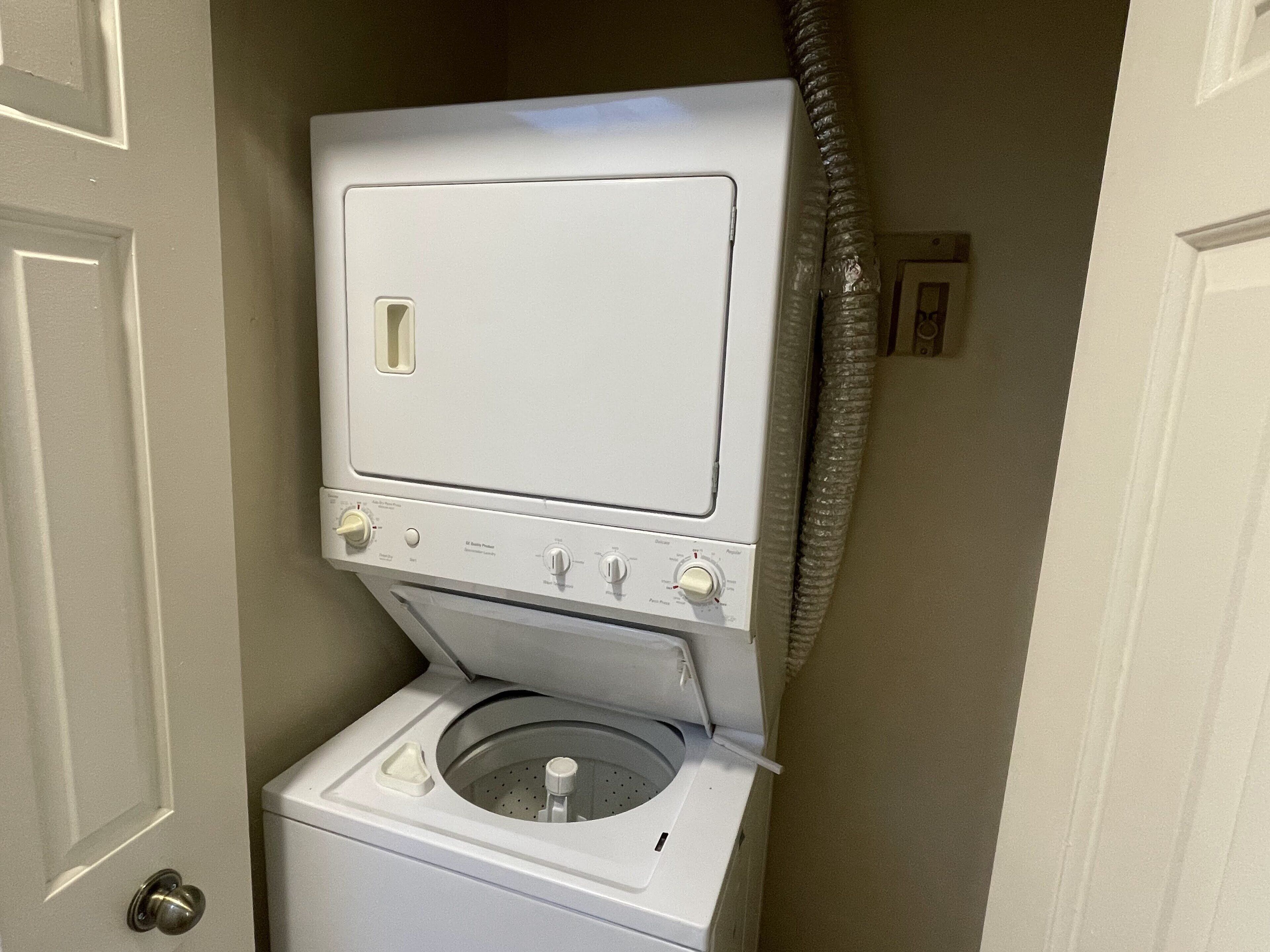 A compact, white front-loading washing machine with a control panel and a small, circular drum.