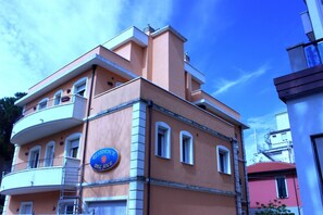 Un edificio a più piani con un cartello blu che riporta la scritta "RESIDENCE DEL SOLE".