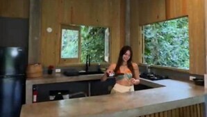 A wooden interior with a bar area, bar stools, and a window providing a view of greenery. - Indomitable Chalet @ El Yunque Zone (Benítez)