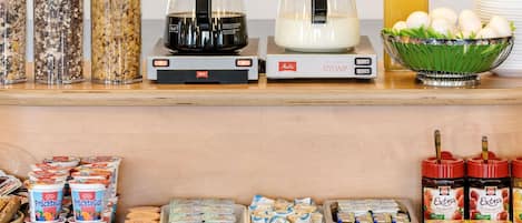 A breakfast buffet with various food items and beverages.