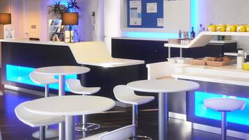 A modern reception area with a reception desk, seating area, and a sign that reads "RECEPCIÓN".