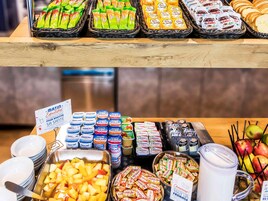 A breakfast buffet with various food items and beverages.