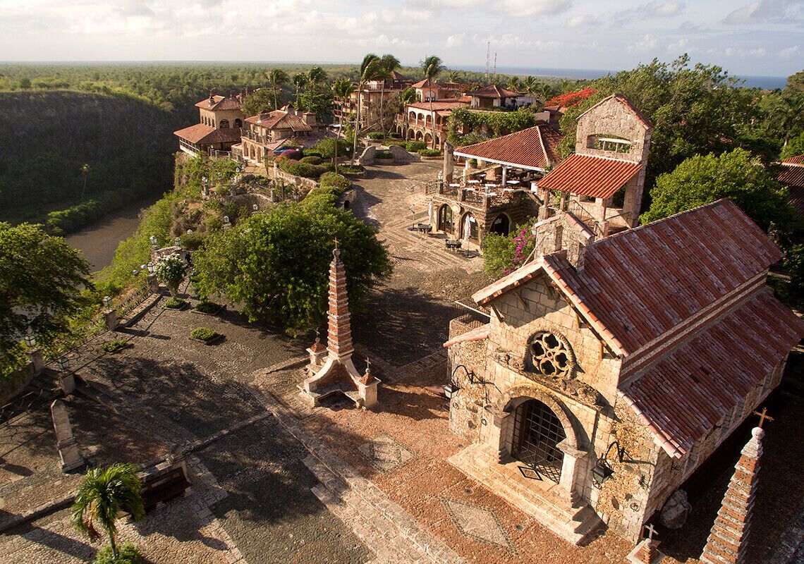 An old town with historic buildings, a church, and a river.
