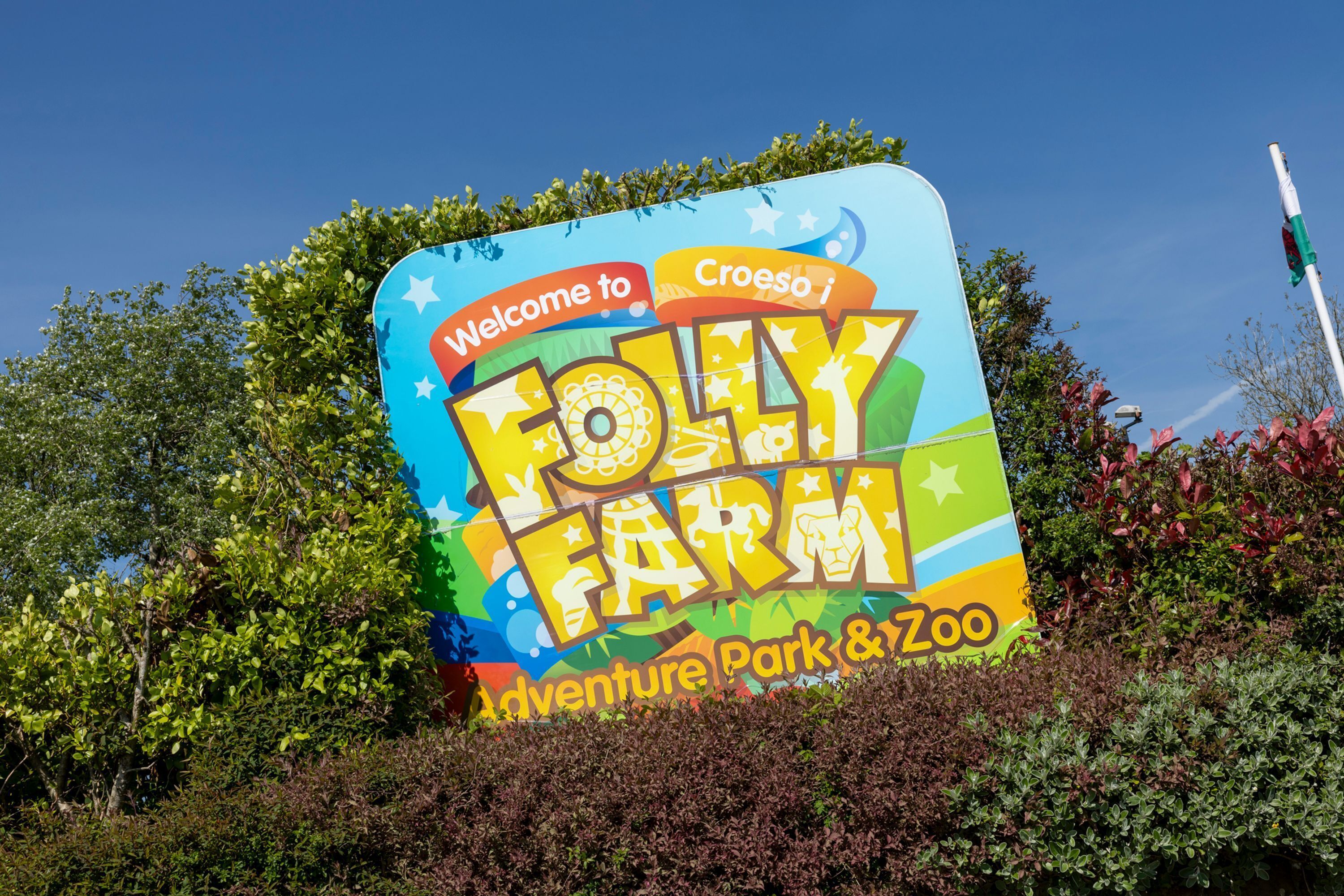 A colorful sign for Croeso i Follty Farm, an Adventure Park & Zoo.