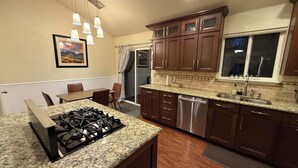 A kitchen with granite countertops, stainless steel appliances, and wooden cabinets. - Heber Valley Base Camp: convenient location, modern amenities, pleasant spaces (Heber City)
