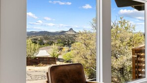 A room with a large window offering a view of a mountainous landscape. - The Sanctuary at Prescott Heights |Majestic Views |Luxe Prescott Sanctuary |Golf (Prescott)