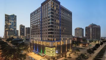 A high-rise hotel with a modern design, multiple floors, and a prominent entrance.