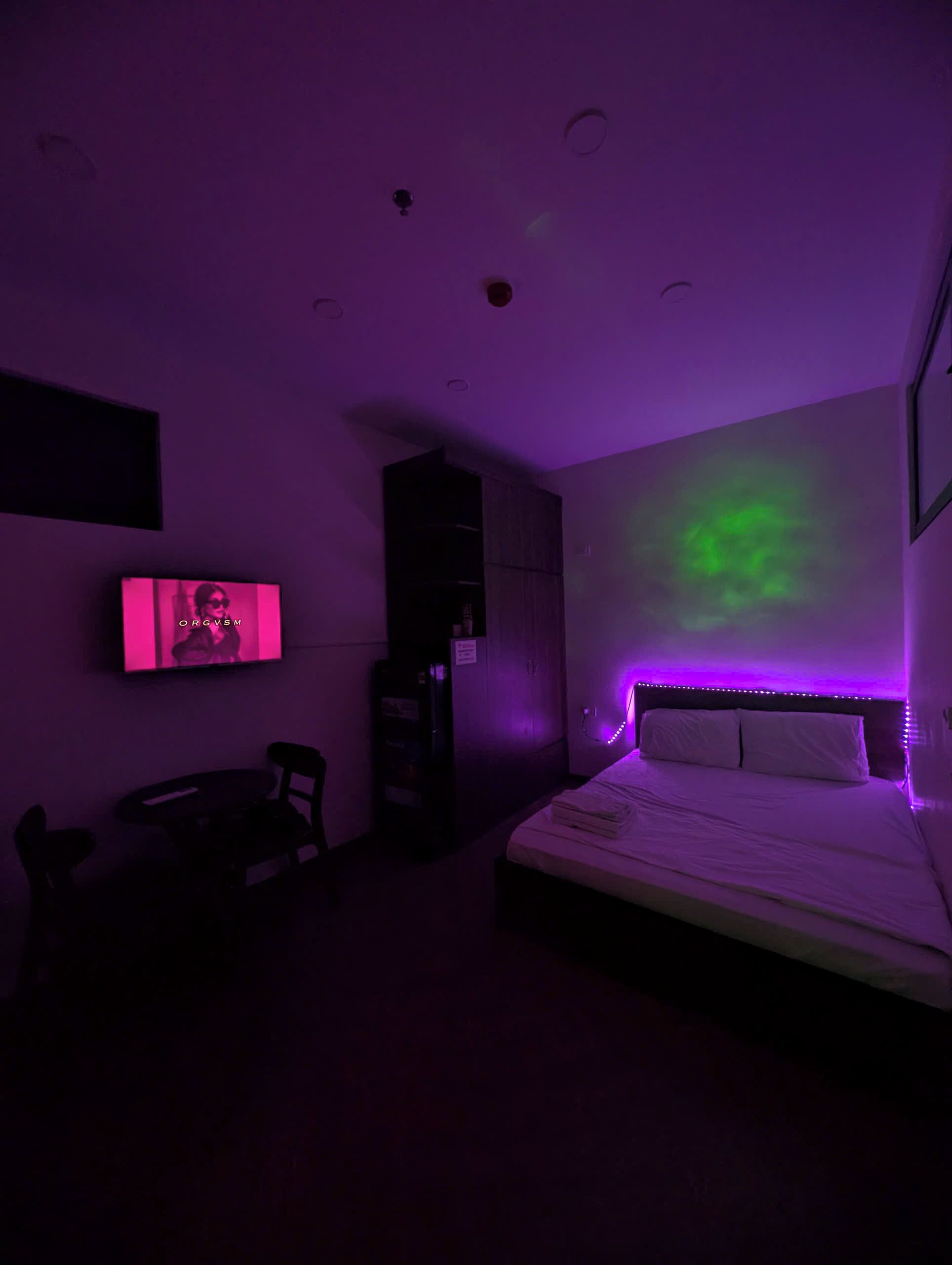A room with a bed, a desk, and a television.