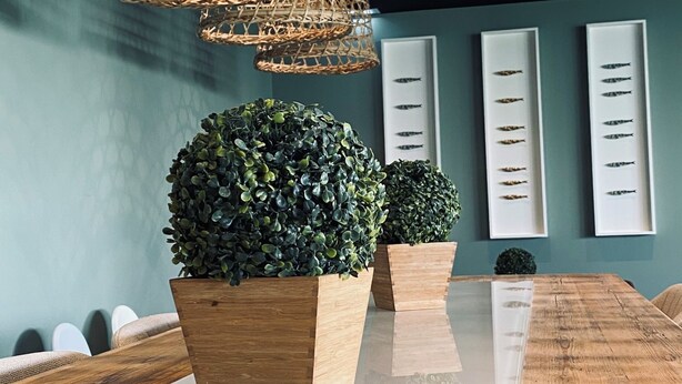 A modern interior with a wooden table, wicker pendant lights, and potted plants. - Albufeira Lounge Hotel (Albufeira)