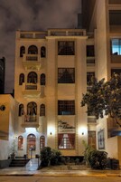 Fachada de hotel con varios balcones, una entrada central con escalones y un letrero que dice "Casa Martin".