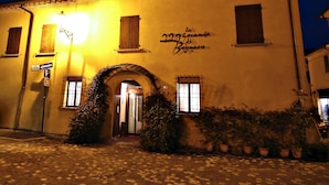 A building with a sign reading "La casa di Bagmara" and a street sign indicating a parking area. - La Locanda Di Bagnara (Bagnara di Romagna)