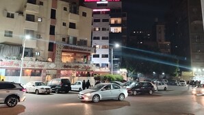 A hotel named 'Dreamers Hotel' with multiple floors and balconies, surrounded by parked cars and streetlights. - Dreamers Cairo Hotel (Giza)
