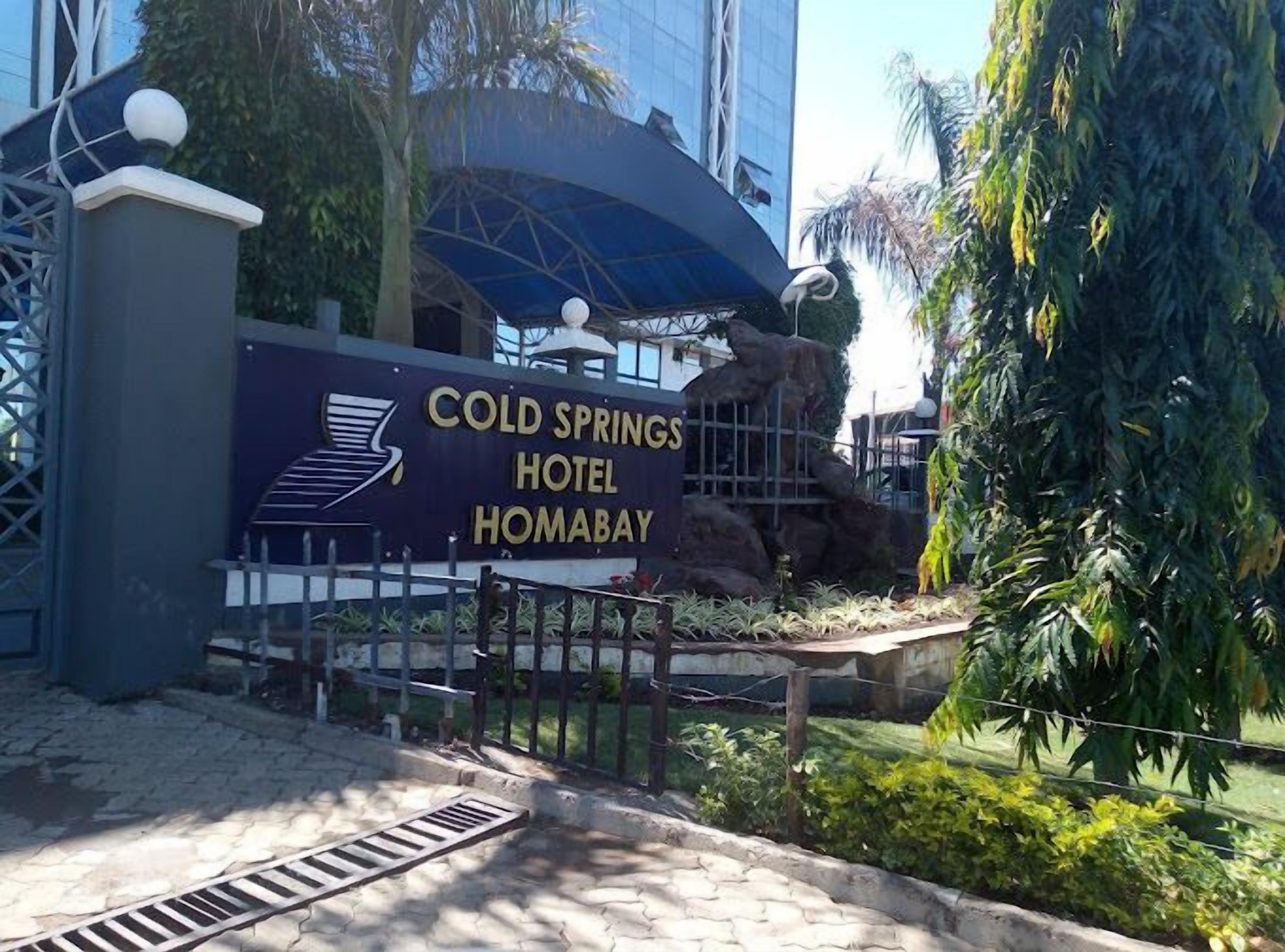 A sign for Cold Springs Hotel in Homabay, featuring a modern design with a logo and text.