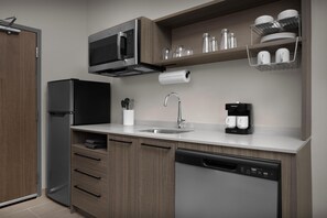 A modern kitchen with a built-in microwave, coffee maker, and dishwasher. - Home2 Suites By Hilton El Paso East Loop 375 (El Paso)