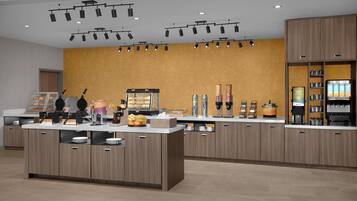 A modern kitchen area with a central island, overhead lighting, and a variety of appliances and food items.